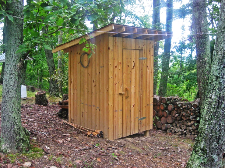 an outhouse built into a pile of wood