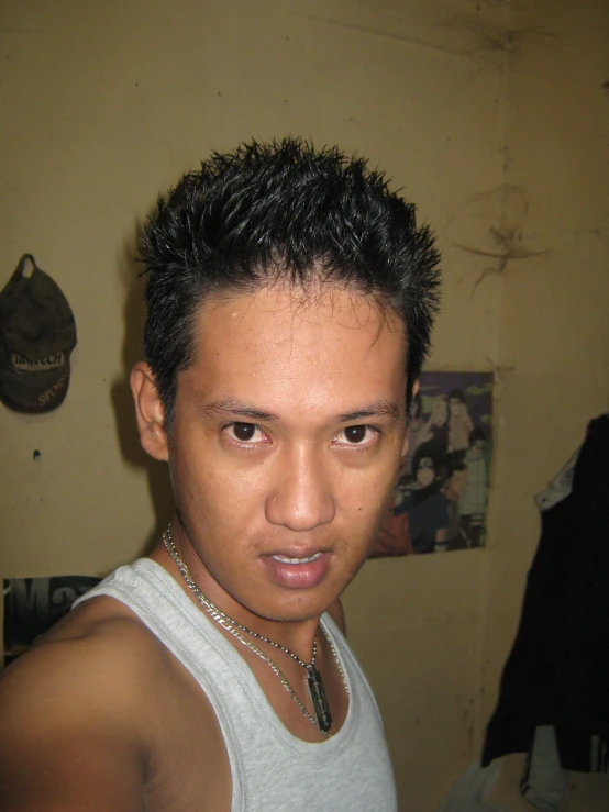 a guy with black hair looks at the camera