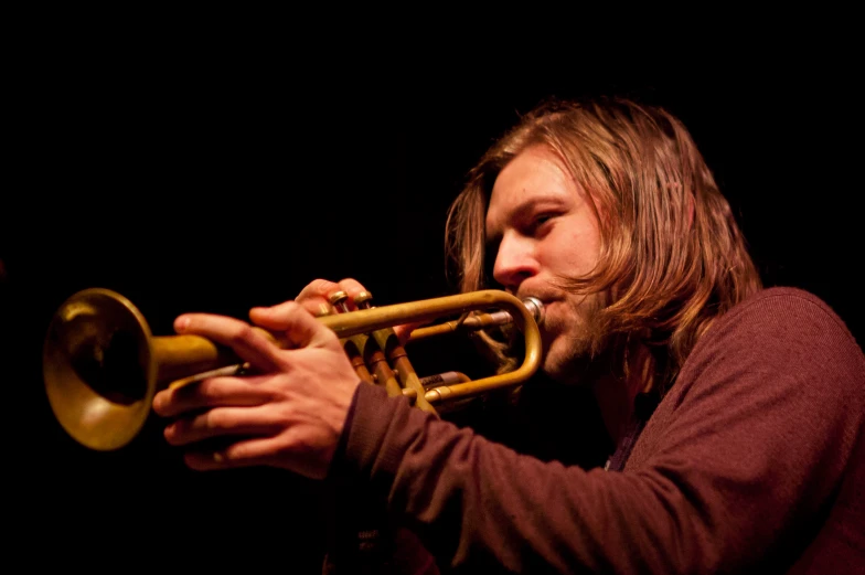 a close up of a person playing a trumpet