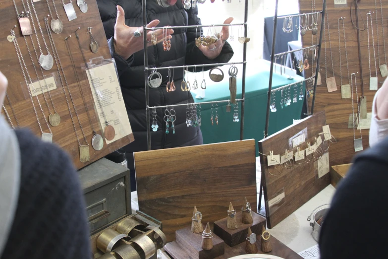 the woman is buying jewelry with other items at the store