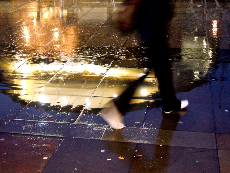 a person walking down the street holding an umbrella