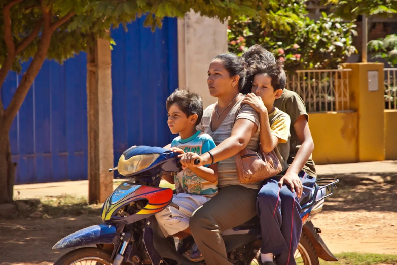 some people riding on the back of a motorcycle