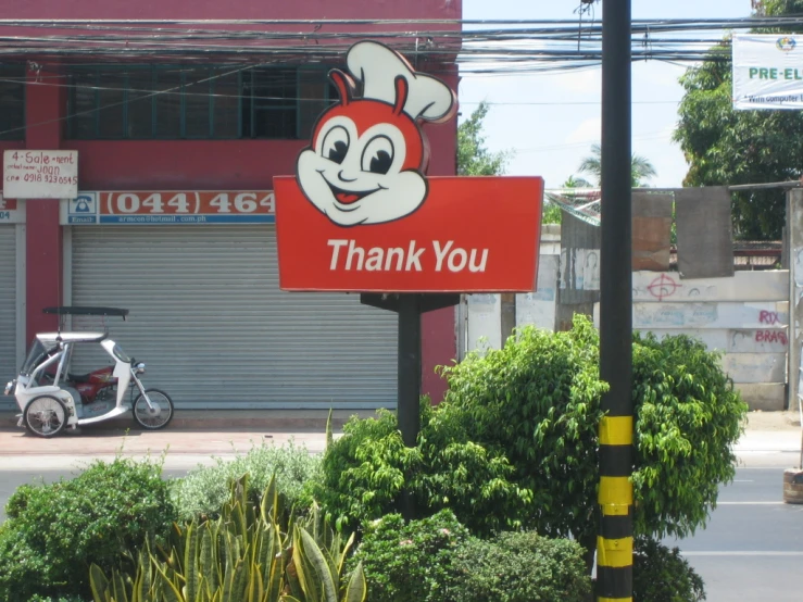 a thank you sign is in front of a motorcycle