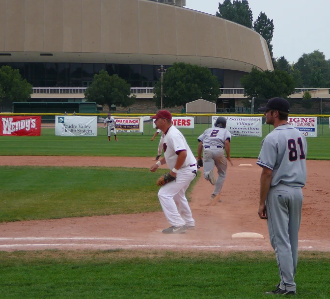 the men are playing baseball on the field