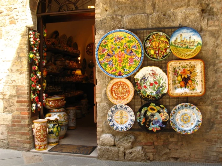 colorful plates displayed on wall next to brick building