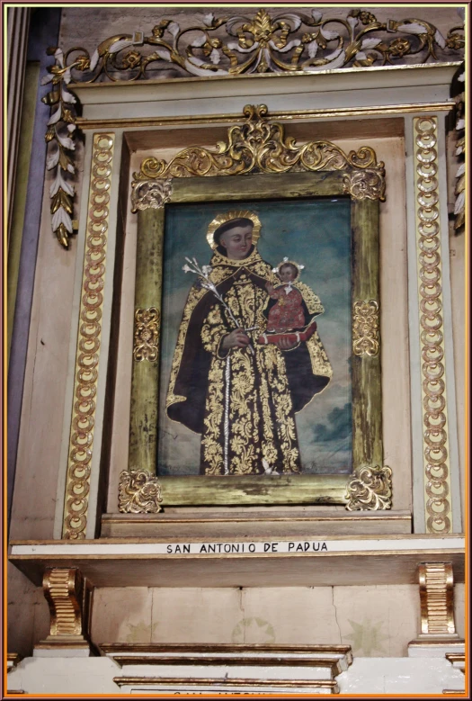 painting with gilded frame inside a building