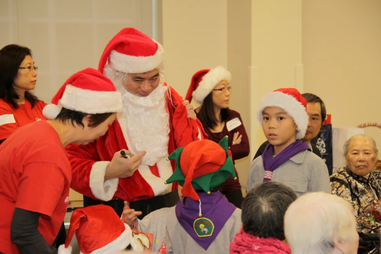 a group of people that are dressed up in santa hats