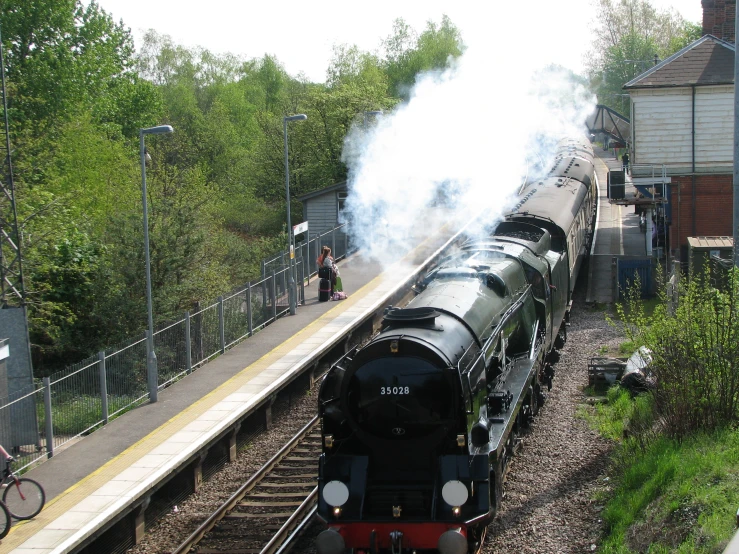 a train engine carrying carts down a track