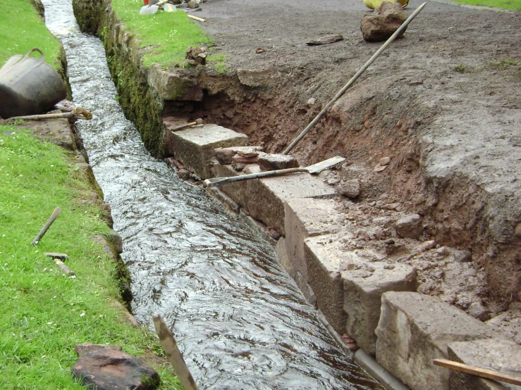 two guys working to repair a small stream