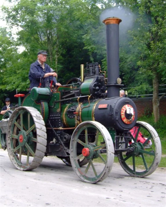 an old fashioned train engine sitting on the road
