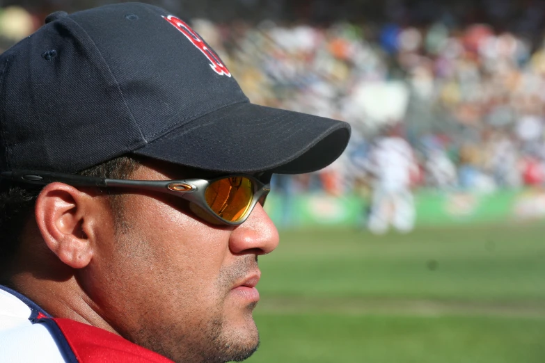 a man with sunglasses and a hat in a field