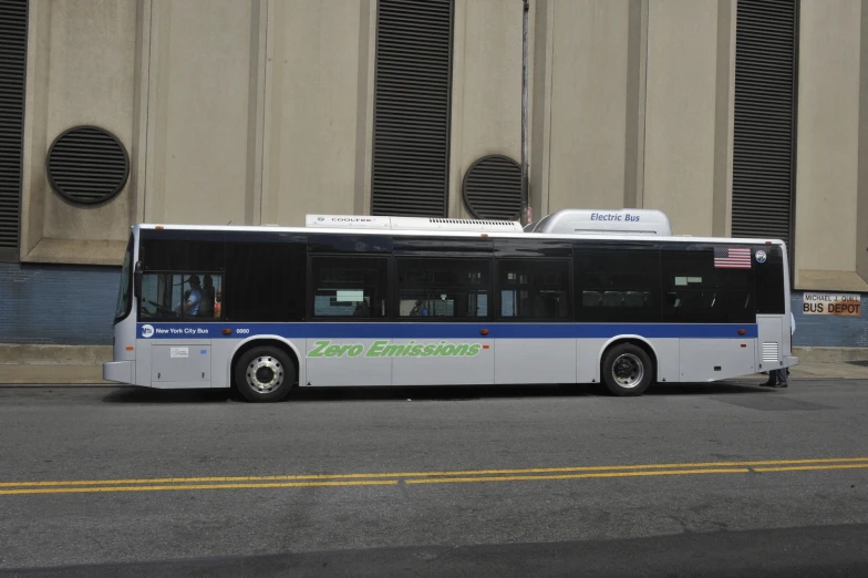 a city bus on the street in front of a building