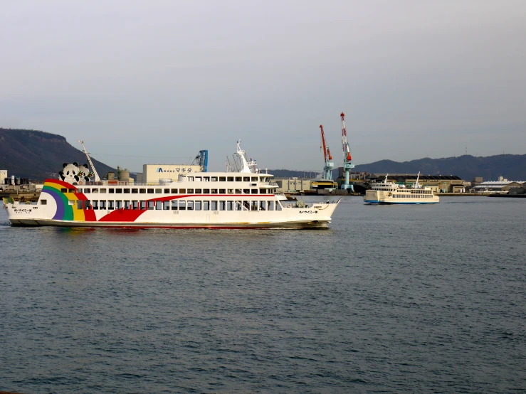 a ship docked next to some other ships