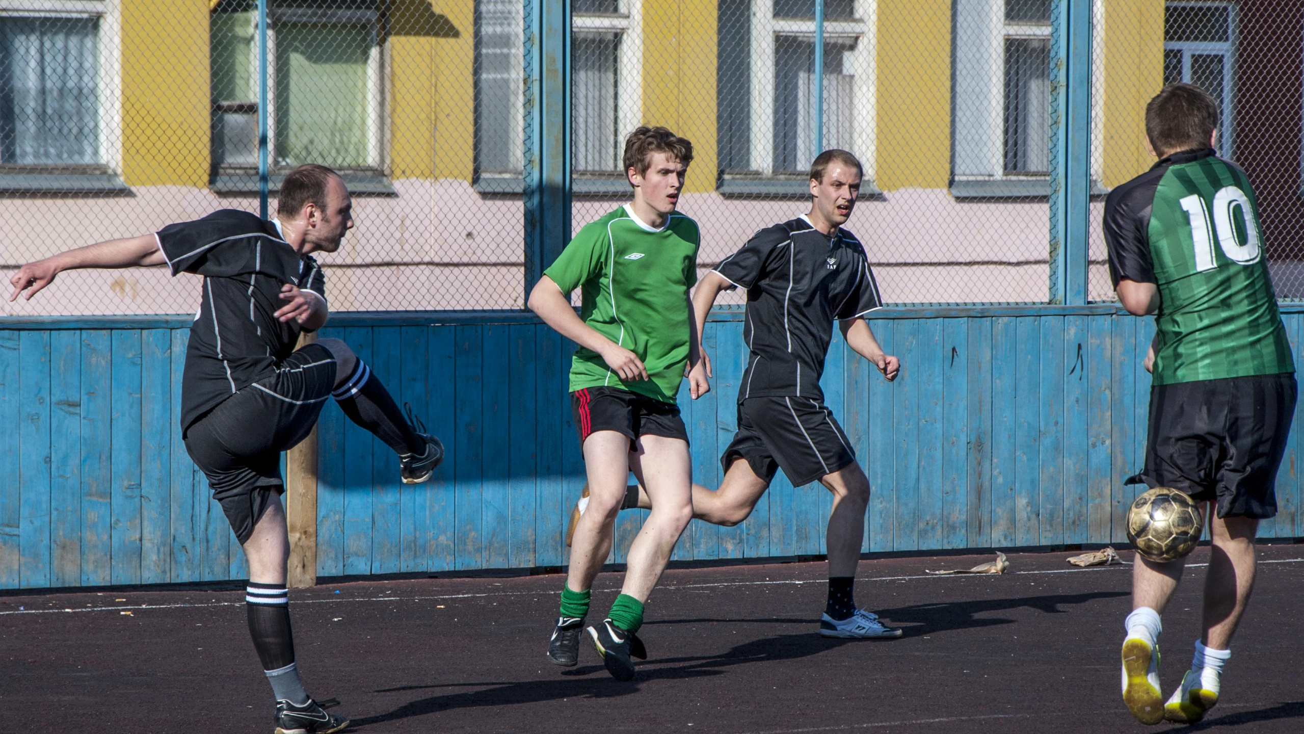 a group of men playing soccer against each other