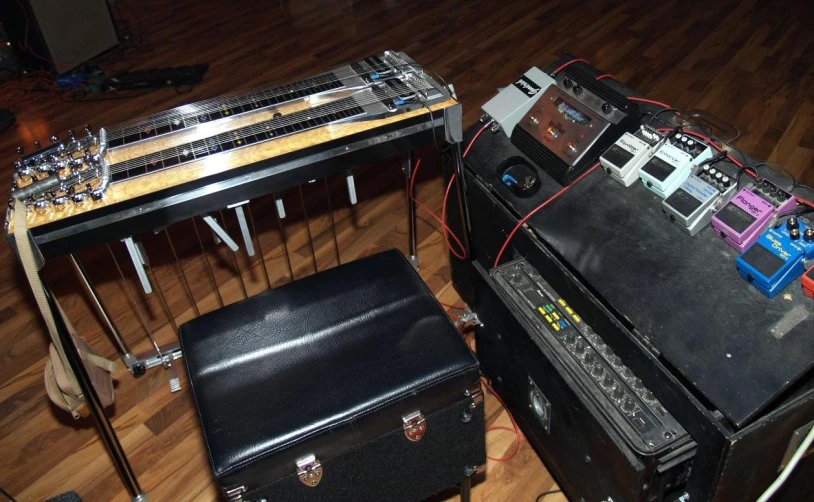 a table with guitar and pedals on it