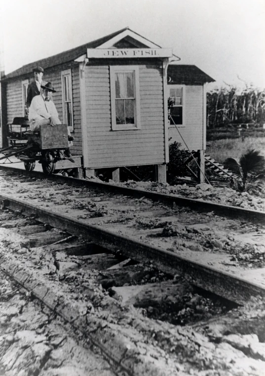 a man is riding a cart pulled by a train