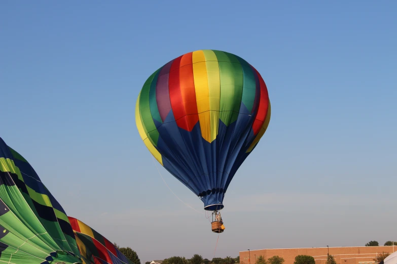 the colorful  air balloon is flying in the sky