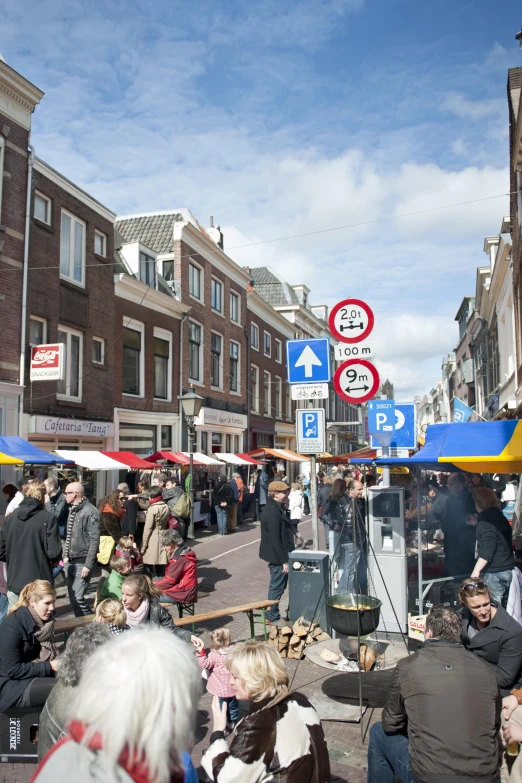 an intersection near some houses and buildings with people on it