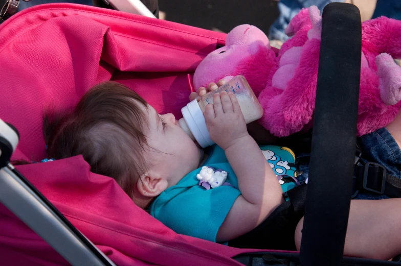 a baby that is laying down with a stuffed animal