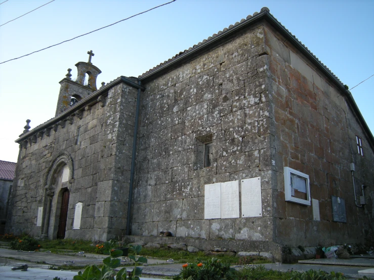 a brown church is covered in green and white vines