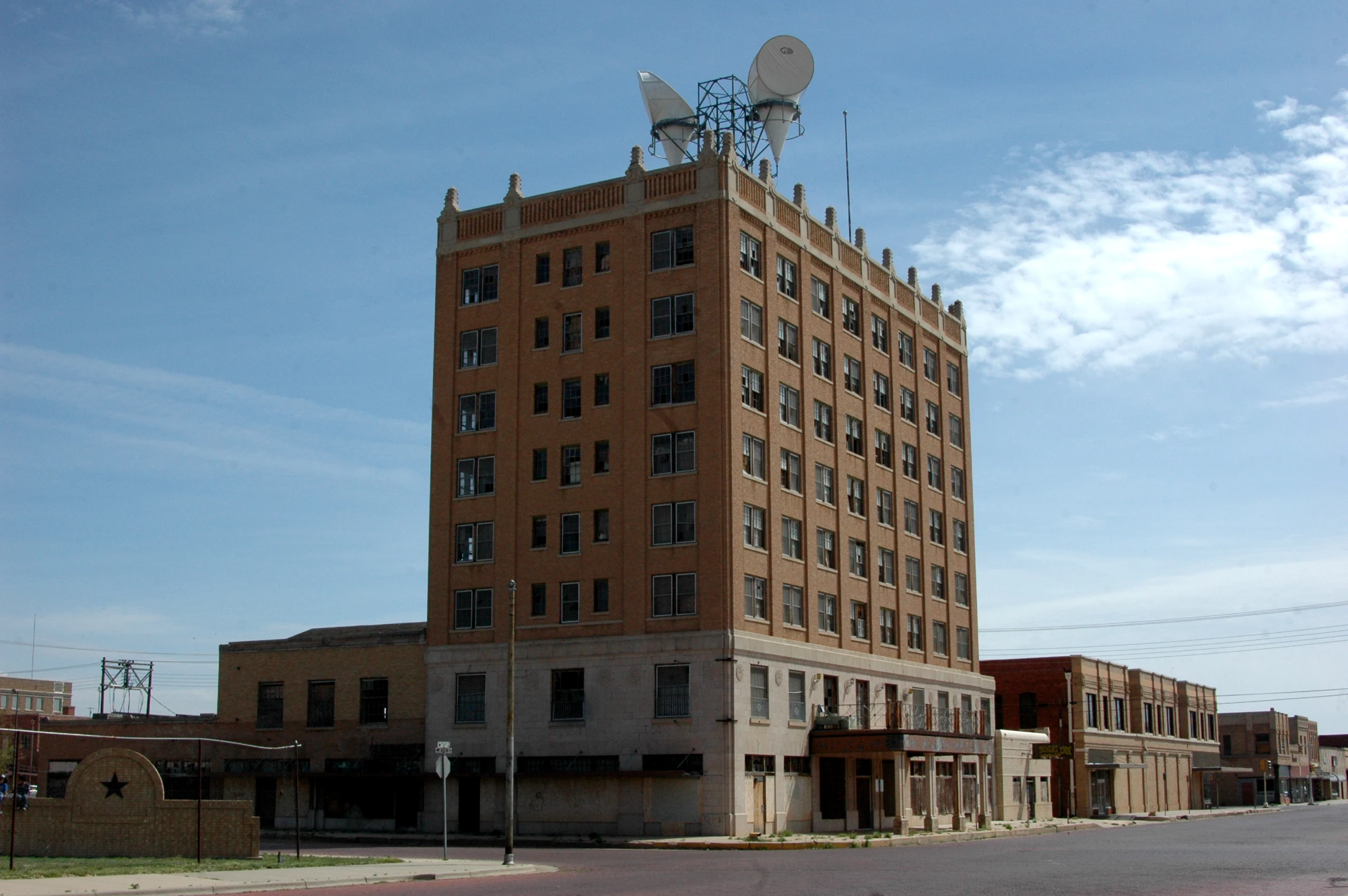 a large brick building with a satellite antenna on top