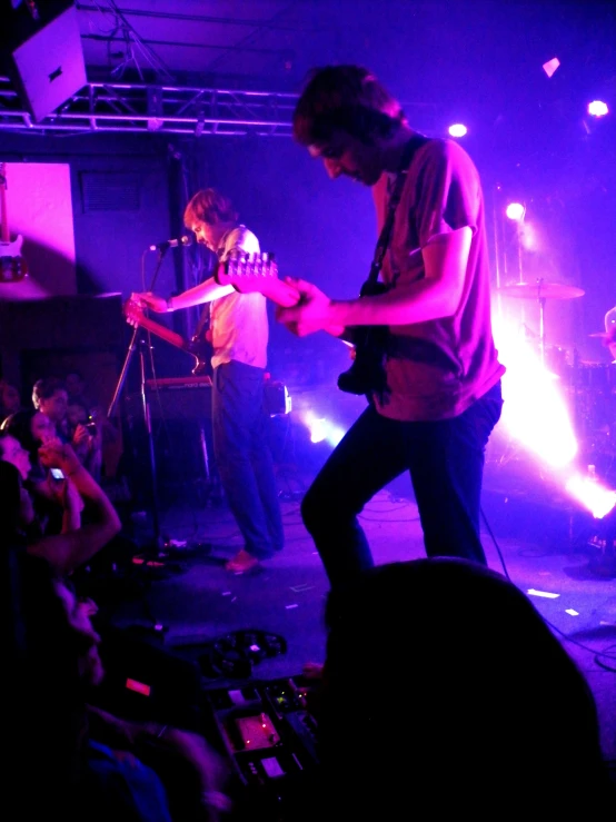 a man standing on a stage holding onto a microphone