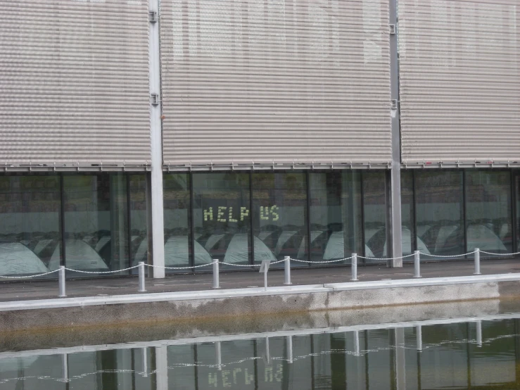 an outside view of a building that has some writing on the windows