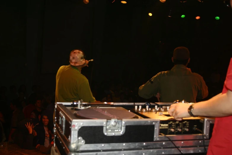 a dj mixes up a track on his turntables