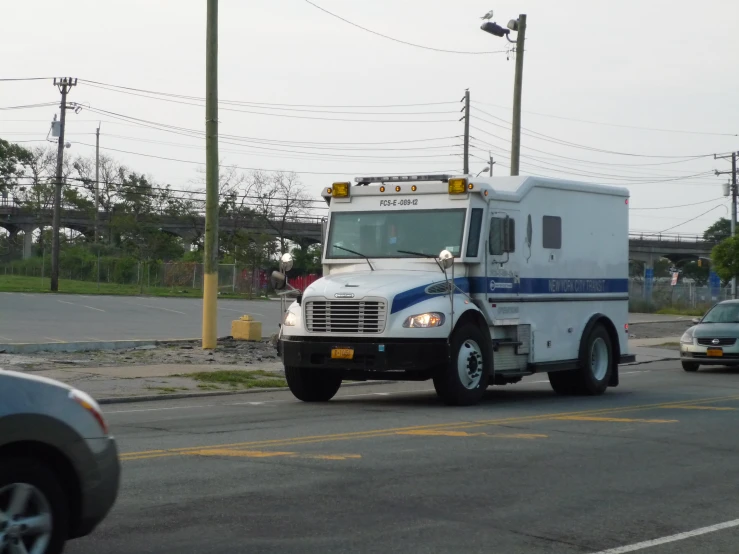 the ambulance is coming down the road in traffic