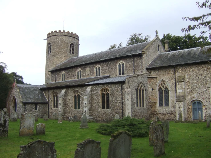 an old church with stone walls and towers