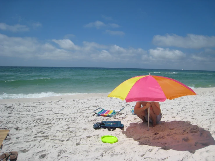 beach scene with bright colors, umbrella and water