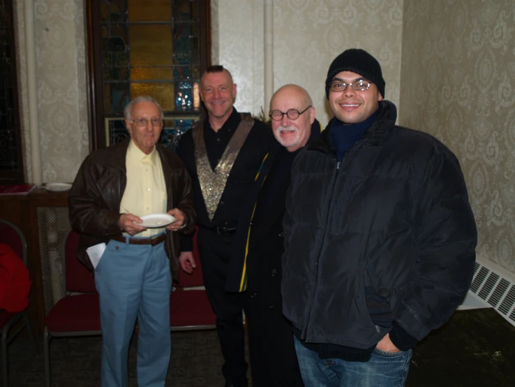 group of men posing for the camera wearing winter clothes