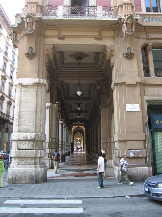 a group of people standing in front of an ornate entrance way