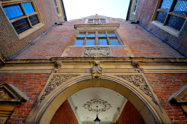 an arch between two buildings with open windows