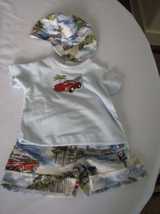 an infant boy's clothes set sitting on a table