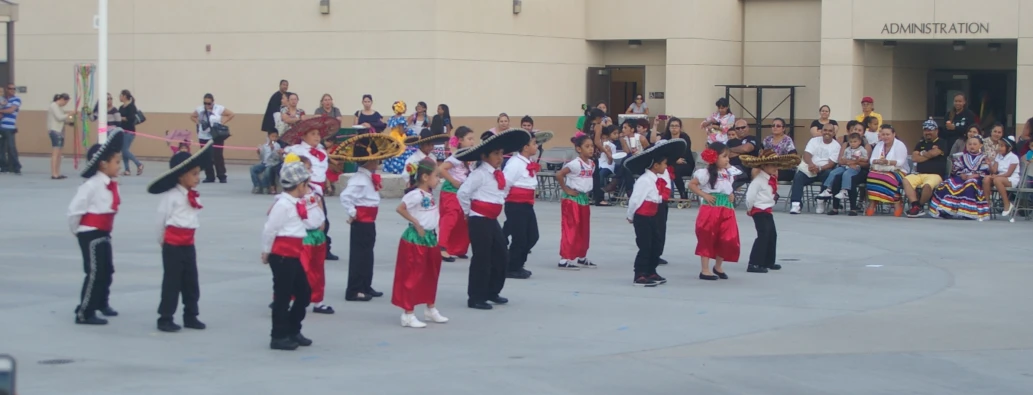 several children dressed in different colors and their instruments