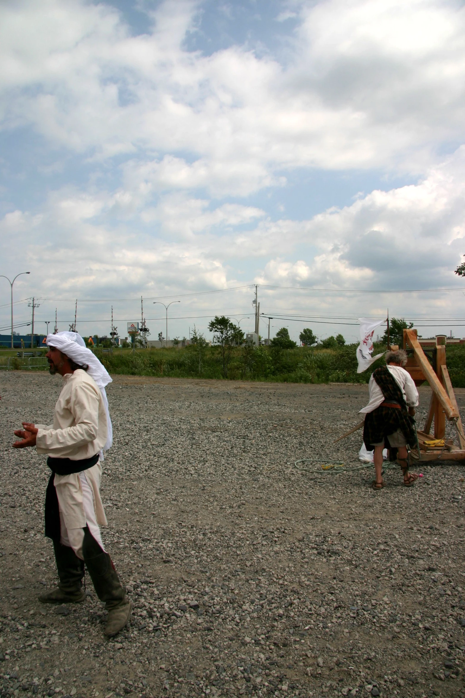 two men with large hats carrying soing on their backs