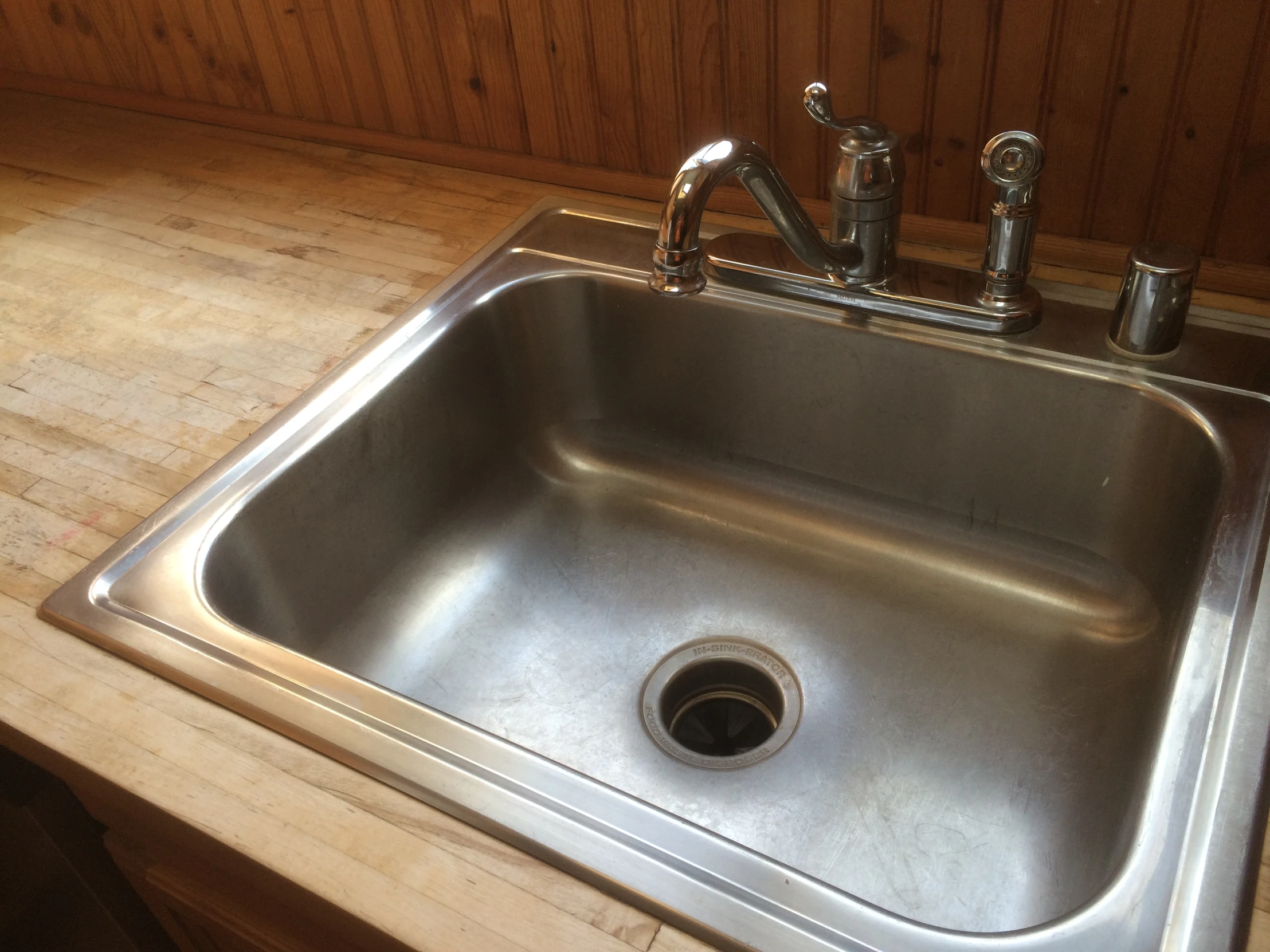 a stainless steel sink in a small kitchen