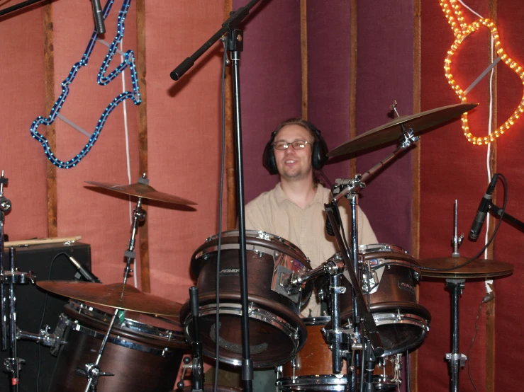 a man that is standing in front of a set of drums