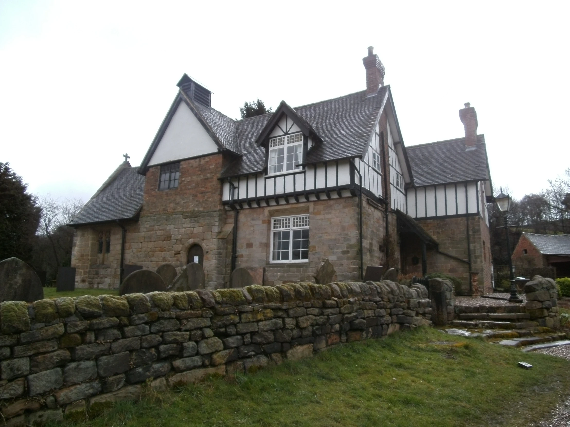 a large brick building has a stone wall