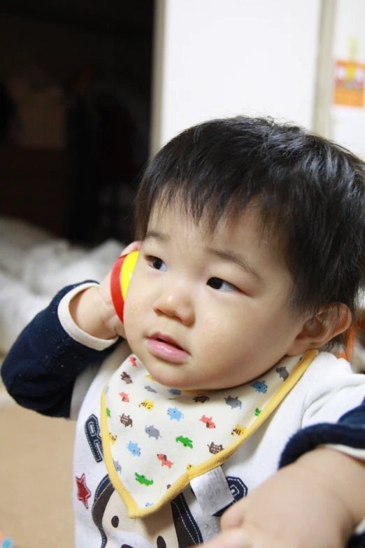 an adorable little boy holding his hands behind his head