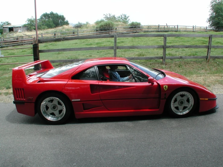 the ferrari is parked on the side of the road