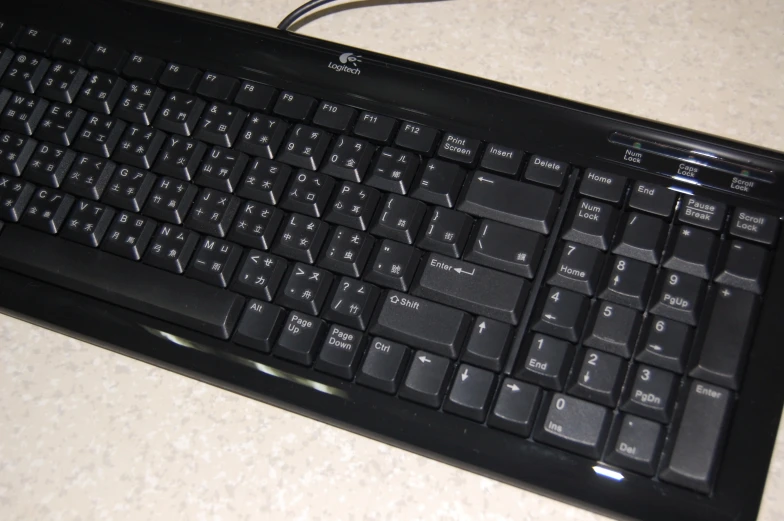 a black keyboard and it's light on sitting on a counter