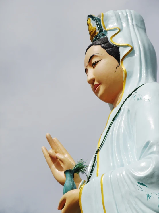 a large statue of a person holding two hands