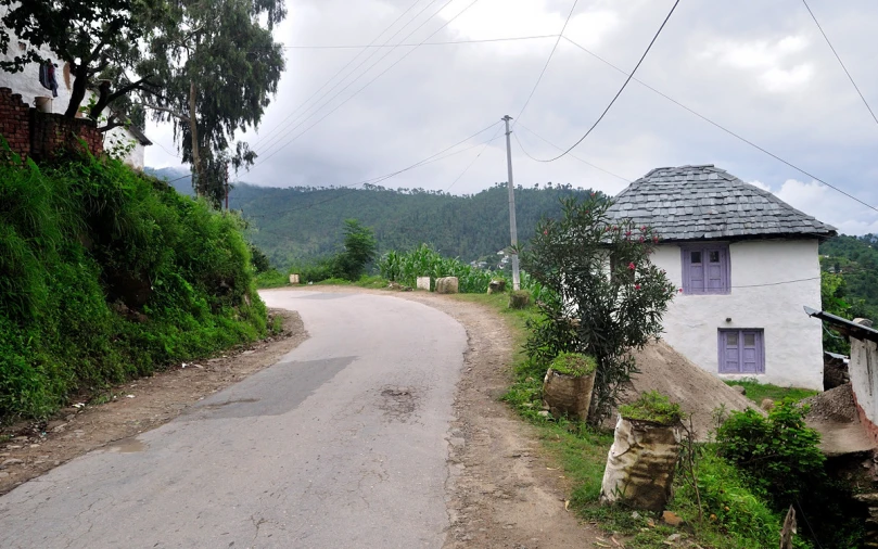 a white building sitting on the side of a road