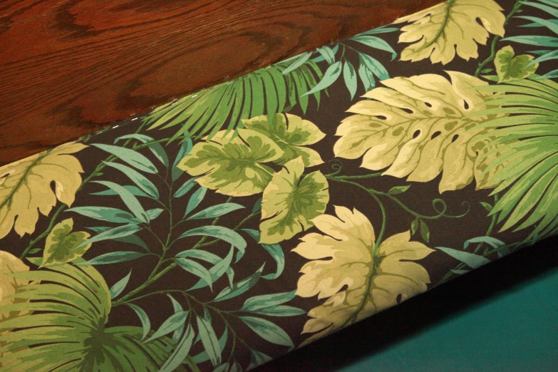 the corner of a table with a floral patterned fabric