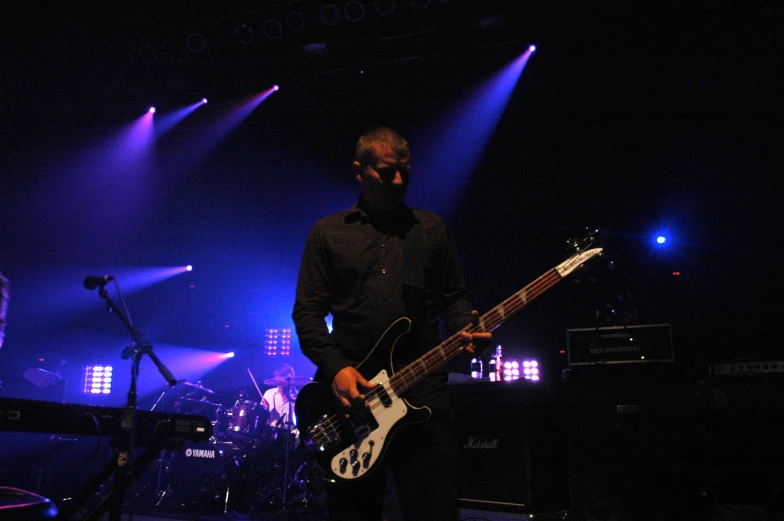 a man that is playing on some kind of guitar