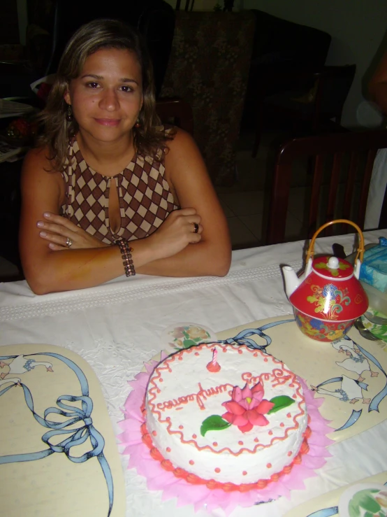 the young woman sits in front of her birthday cake