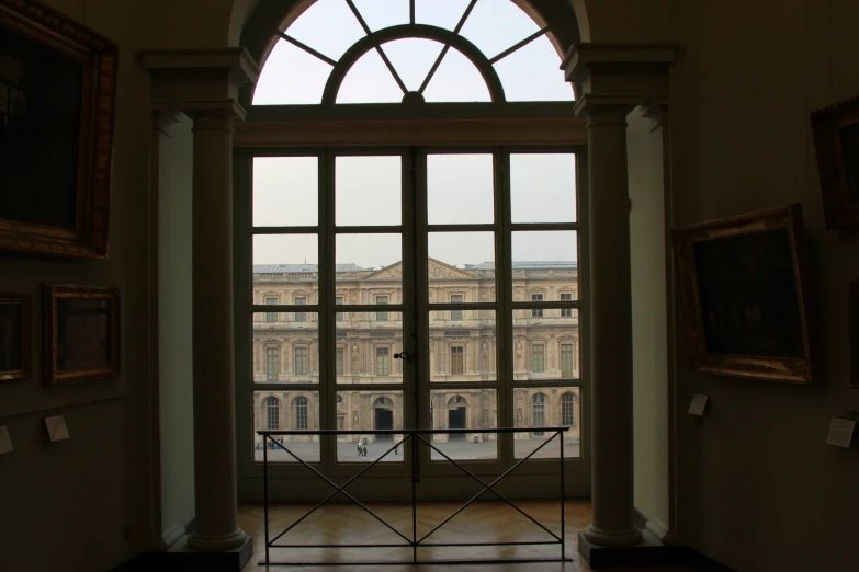 a view of an entrance into a very large building from the other end of a long room