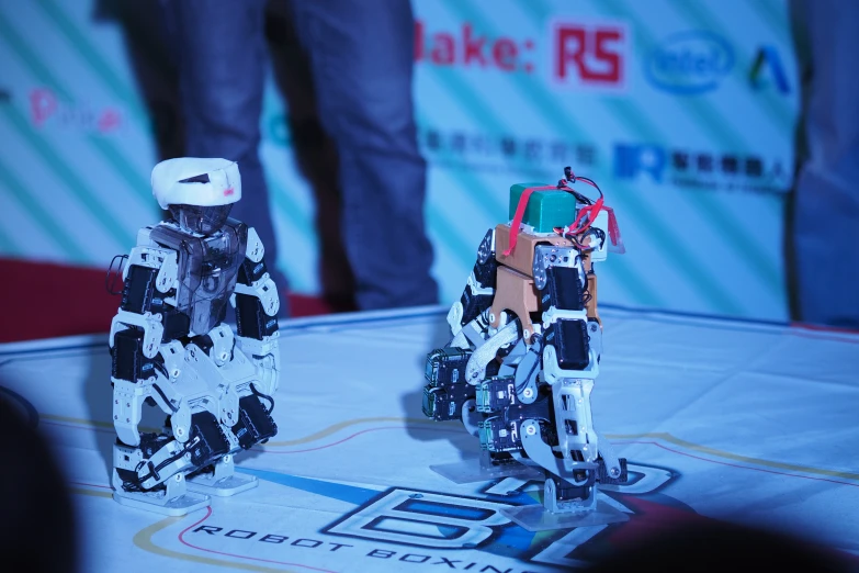 a po of some robot paper toys on a stage